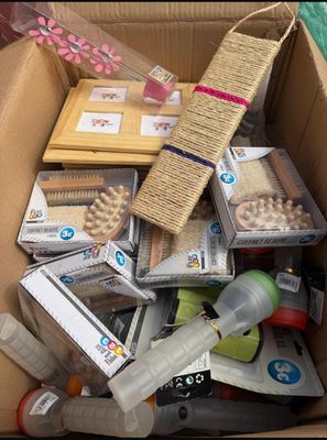a cardboard box filled with assorted items on the floor