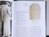 an open book with a picture of a man in a robe and a comb
