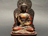 an image of a statue of a buddha sitting on a table