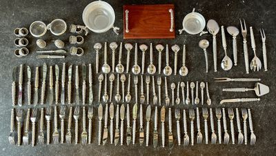 a lot of silverware and silverware on a table