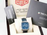 a box with a watch and a card in it