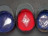three buckets with blue and red lids are lined up on a table