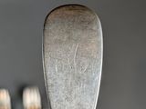 a silver spoon and a fork on a table