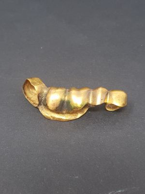 an image of a gold ring on a black surface