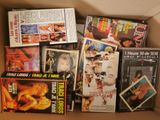 a cardboard box filled with various movies and dvds