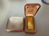 a silver case with a gold bar in it on a table