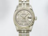 une photo d'une montre Rolex à cadran blanc montée sur un bracelet