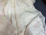 a pile of white linens on a bed