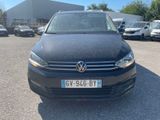the front view of a black volkswagen vw - cross parked in a parking lot