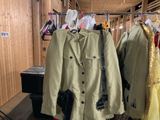 three jackets hanging on a rack in a room
