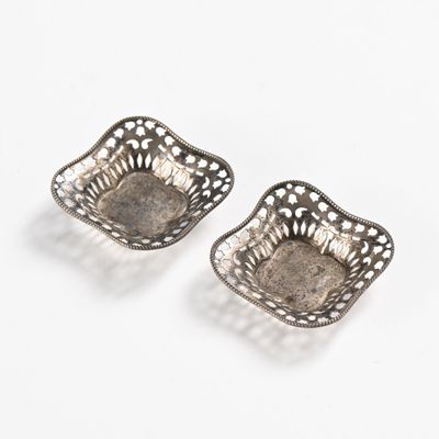 pair of antique silver plated dishes on a white background