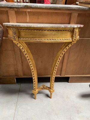 a table with a marble top and a chair next to it