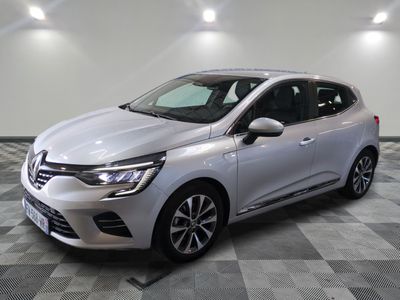 a silver car is parked in a room with a checkered floor