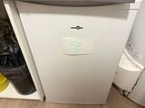 a white refrigerator with a bunch of clothes on top of it