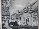 a black and white photo of a street in britain