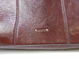 brown leather purse with a zipper on the inside of it
