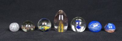 many different colored marbles on a black surface