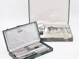 a green case with silverware in it on a white surface
