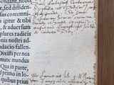 an old book with writing on it sitting on a table