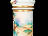 a white and gold vase with a painting on it