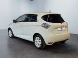 a picture of a small white car parked in a showroom