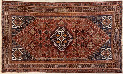 an antique persian rug with a geometric design