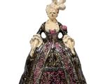 a figurine of a woman in a black dress with pink flowers