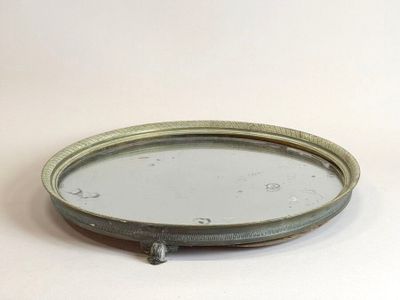 a small round mirror sitting on a white surface