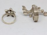 two silver rings and a silver ring on a white surface