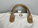 an image of a white bag with brown handles on a gray background