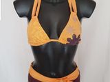 orange and brown bikini with flower detail on bust
