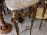 three tables and two stools in a room