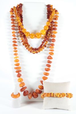 an image of a necklace, bracelet, and pillow on a mannequin