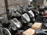 a lot of scooters that are parked next to each other
