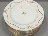 a stack of six plates with gold trims on them