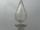 a clear glass bottle with a glass stopper on it