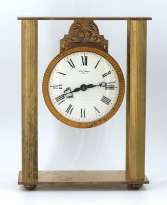 a wooden clock with roman numerals on the face