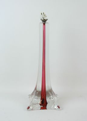 a glass vase with a candle inside of it on a white surface
