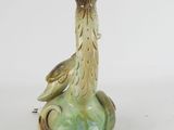 an image of a glass bottle with a bird on it