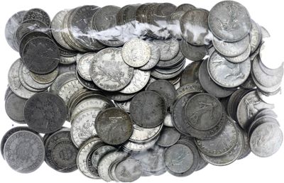 a pile of silver coins sitting on top of a white surface