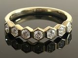 an image of a diamond ring on a reflective surface