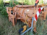 a tractor that is sitting in the grass by itself