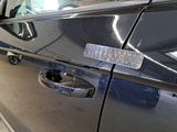 a close up of a car door handle with a sticker on it