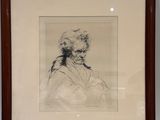framed drawing of a man in a turban sitting in front of a white wall