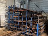 many stacks of steel pipes in a warehouse