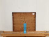 a wooden table with a blue vase on top of it