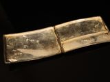 a silver plate that is sitting on a black surface