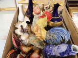 a box full of ceramic figurines and vases