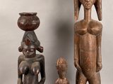 two wooden statues of a man and a woman and a child