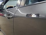 a close up of a car door handle with a sticker on it